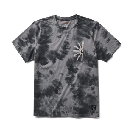 Outdoor adventure enthusiast in casual gear exploring a scenic trail with Roark branding